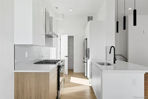 a kitchen with stainless steel appliances a sink and a stove