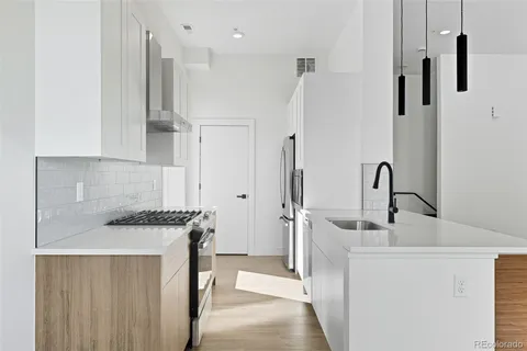a kitchen with stainless steel appliances a sink and a refrigerator