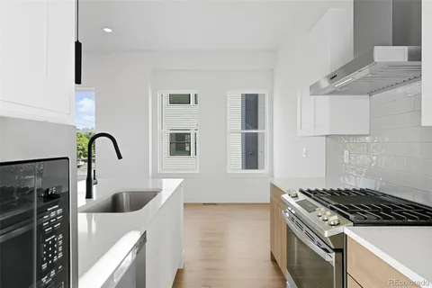 a kitchen with sink a stove and refrigerator