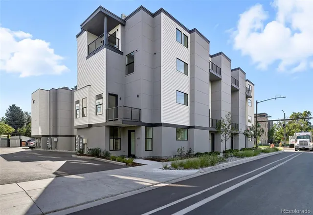 a view of a street with cars parked