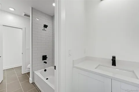 a bathroom with a bathtub and shower