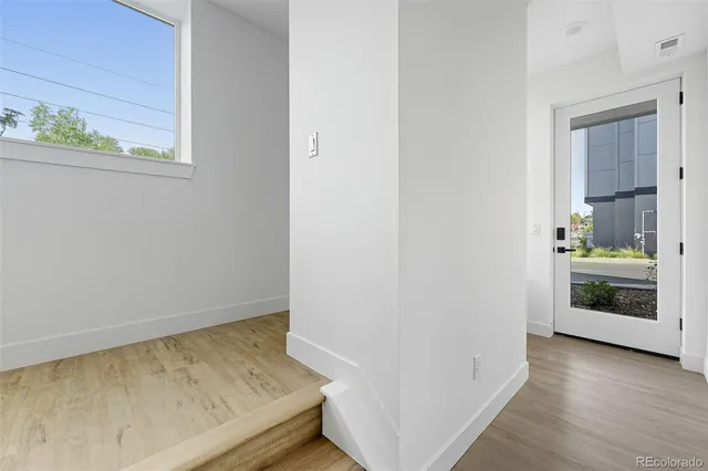 a view of an entryway and wooden floor