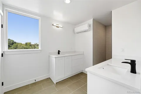 a bathroom with a sink a toilet a mirror and shower