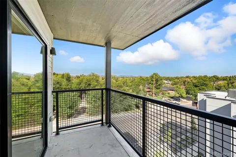 a view of a city with lush green forest