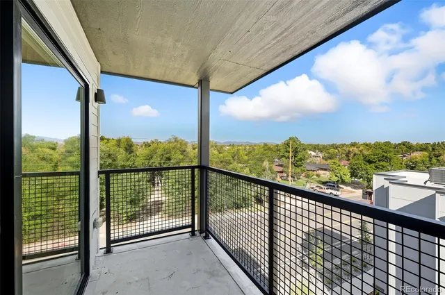 a view of a city with lush green forest