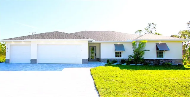 a front view of a house with a garden and yard