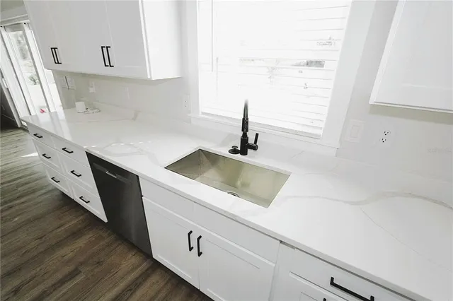 a large room with lots of white furniture