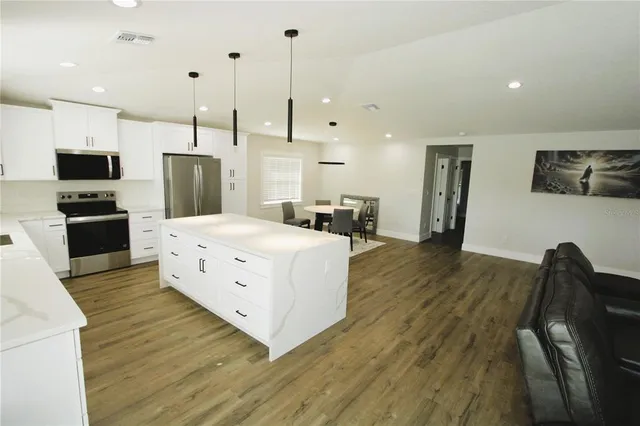 a view of a dining room with furniture and wooden floor