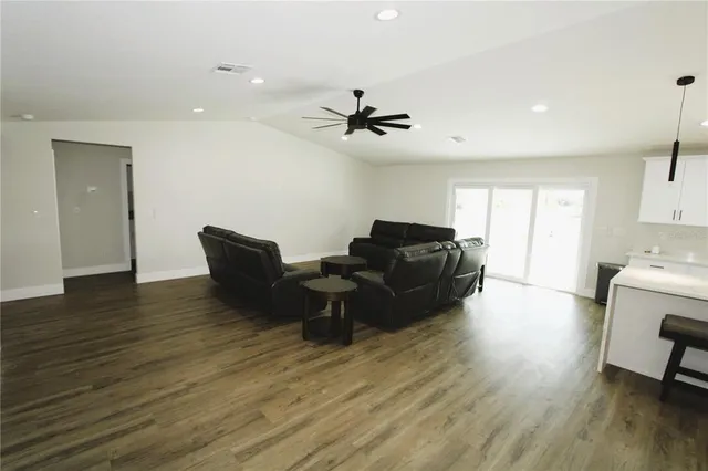 a living room with furniture and a wooden floor