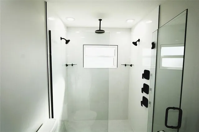 a bathroom with double vanity sink and a mirror