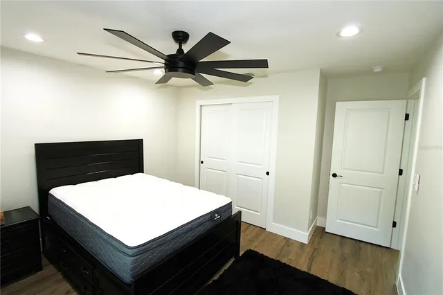 a view of a hallway with wooden floor and entryway