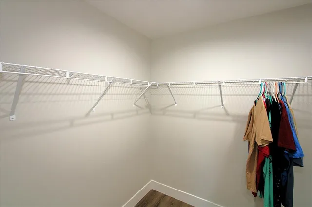 a bathroom with a walk in closet and a mirror