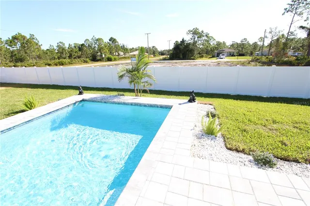 a swimming pool with some trees in the background
