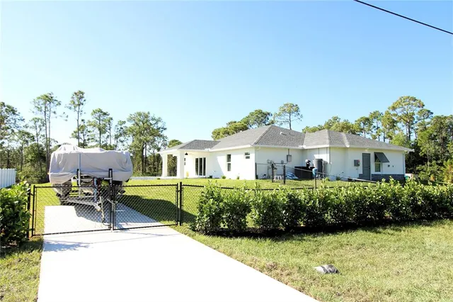a front view of a house with a garden and sitting area