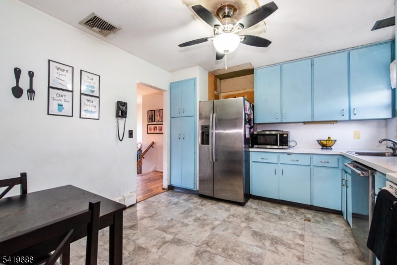 127 Horseneck Road Fairfield, NJ 07004 - Photo 12 of 34 a kitchen with stainless steel appliances granite countertop a refrigerator a sink dishwasher a stove and a refrigerator with wooden floor