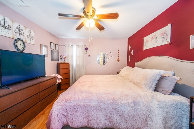 127 Horseneck Road Fairfield, NJ 07004 - Photo 13 of 34 a bedroom with a bed and a flat screen tv