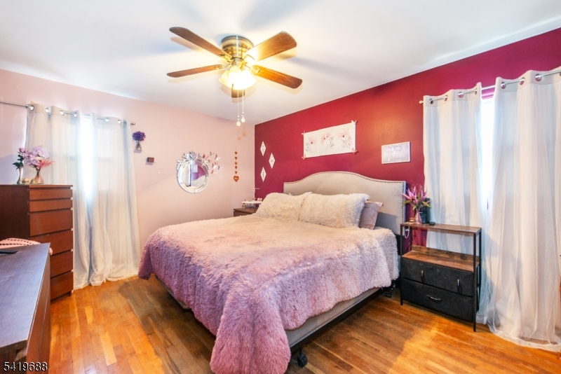 127 Horseneck Road Fairfield, NJ 07004 - Photo 14 of 34 a bedroom with a bed and a chandelier