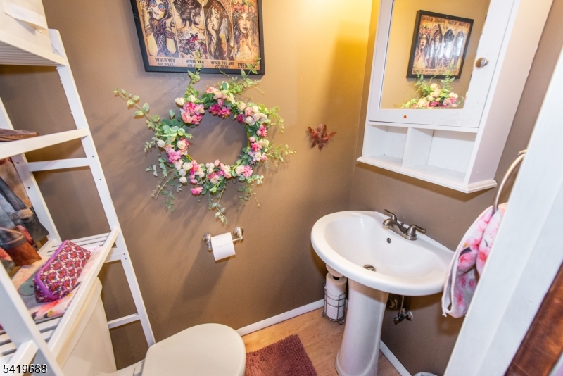 127 Horseneck Road Fairfield, NJ 07004 - Photo 15 of 34 a bathroom with a sink mirror and toilet