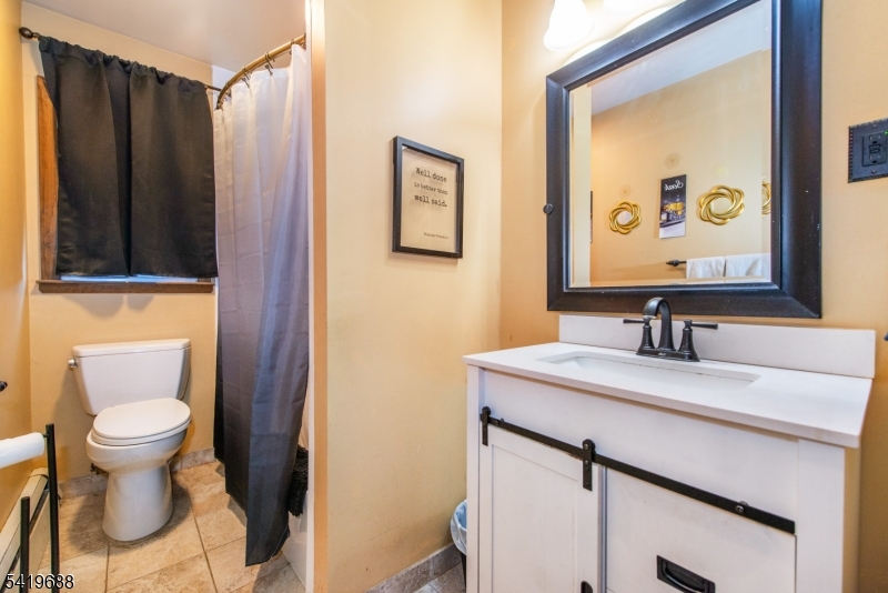 127 Horseneck Road Fairfield, NJ 07004 - Photo 18 of 34 a bathroom with a sink and a mirror