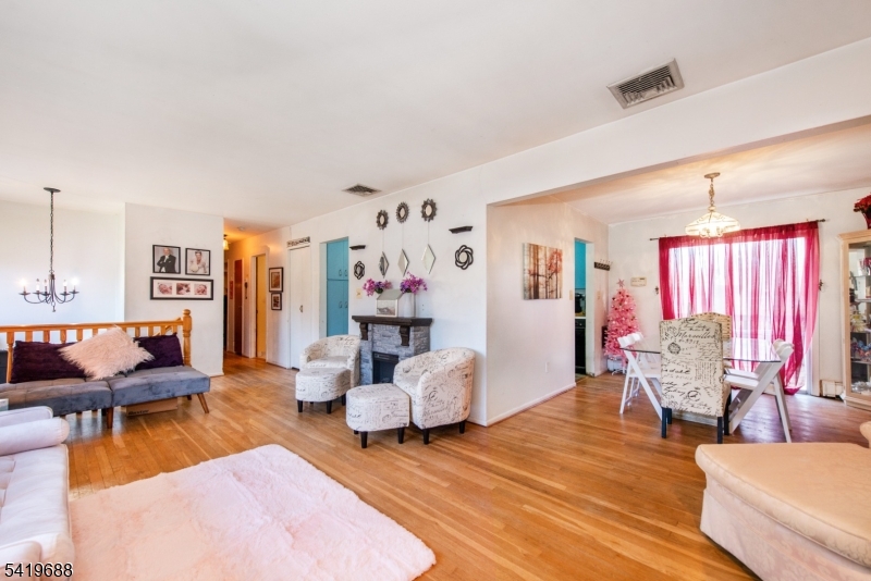 127 Horseneck Road Fairfield, NJ 07004 - Photo 2 of 34 a living room with furniture and a wooden floor