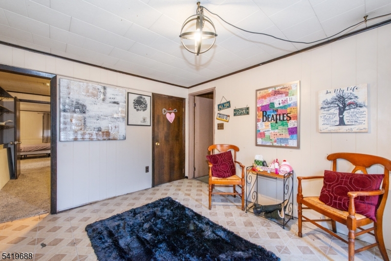 127 Horseneck Road Fairfield, NJ 07004 - Photo 22 of 34 a living room with furniture and paintings on the wall