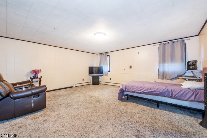 127 Horseneck Road Fairfield, NJ 07004 - Photo 24 of 34 a bed room with a bed and a couch