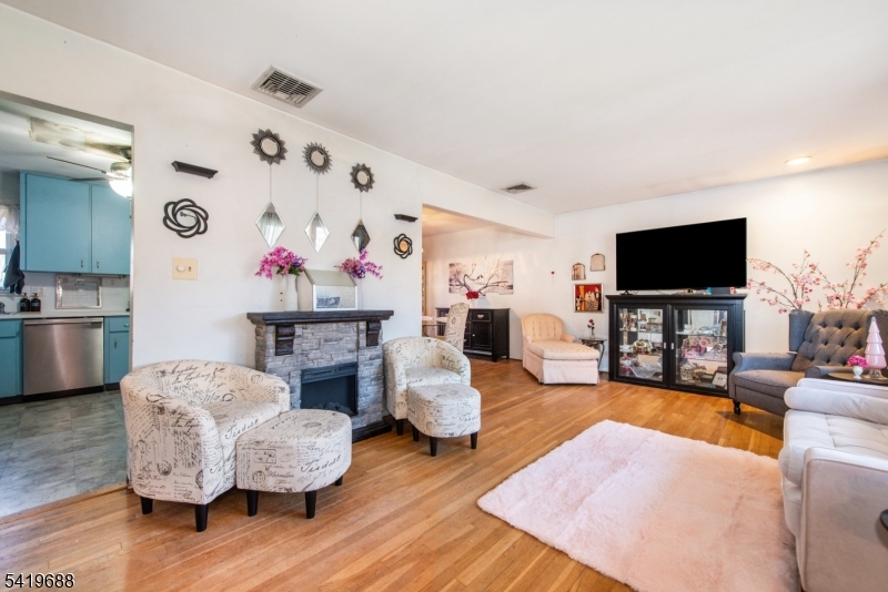 127 Horseneck Road Fairfield, NJ 07004 - Photo 3 of 34 a living room with furniture and a flat screen tv