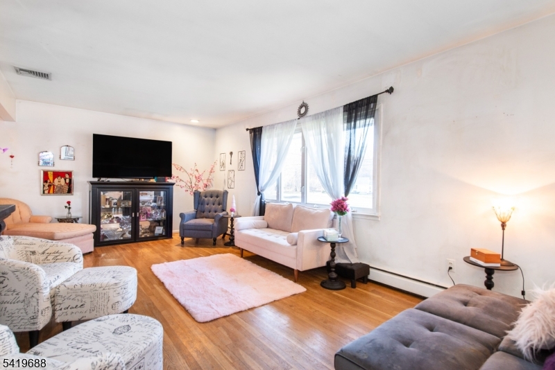 127 Horseneck Road Fairfield, NJ 07004 - Photo 5 of 34 a living room with furniture and a flat screen tv