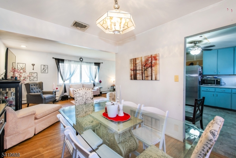 127 Horseneck Road Fairfield, NJ 07004 - Photo 8 of 34 a living room with furniture and a chandelier