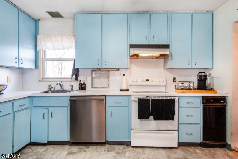 127 Horseneck Road Fairfield, NJ 07004 - Photo 10 of 34 a kitchen with a stove sink and cabinets