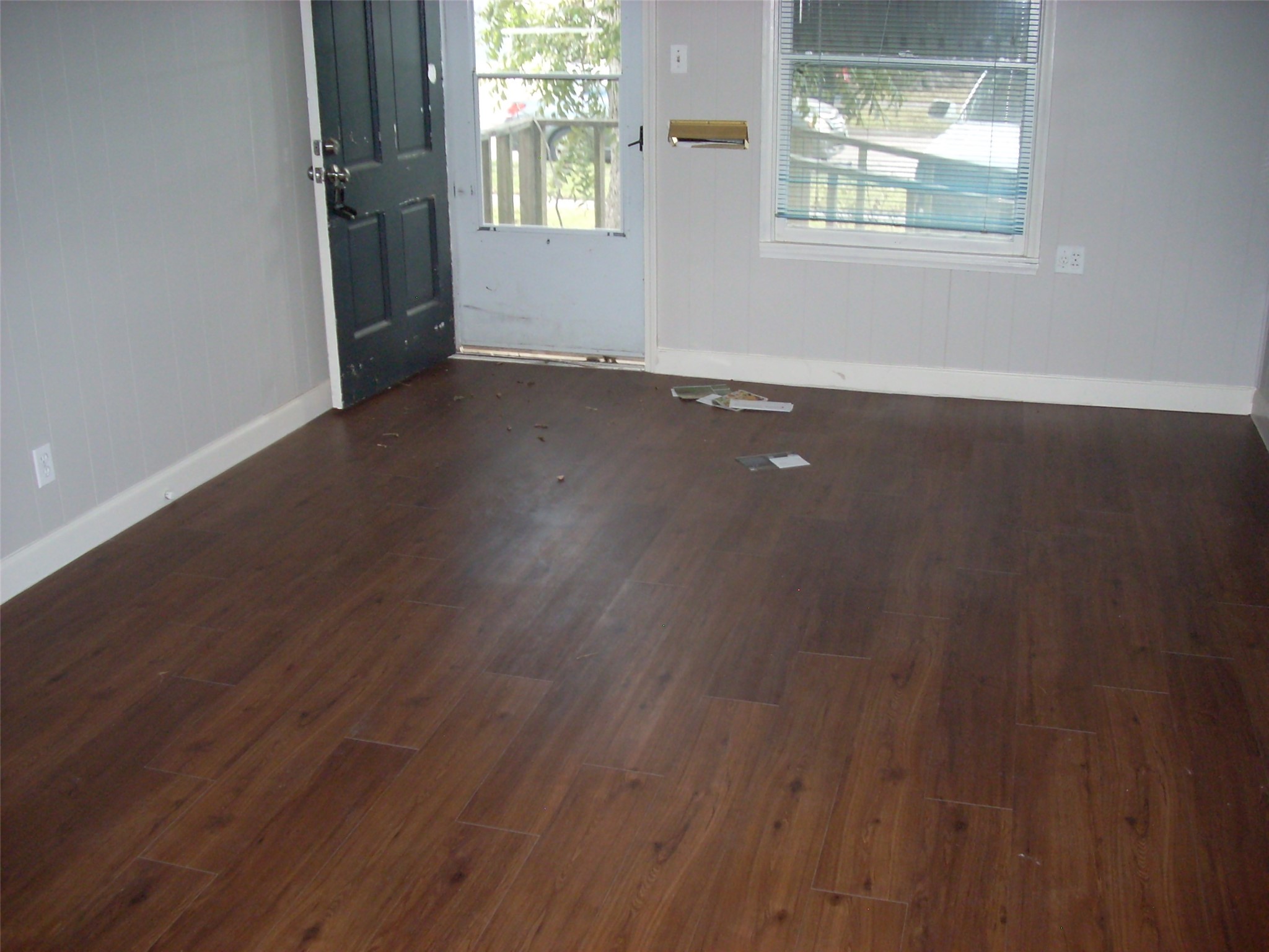 6927 Keller Street Houston, TX 77087 - Photo 2 of 11 an empty room with wooden floor and windows