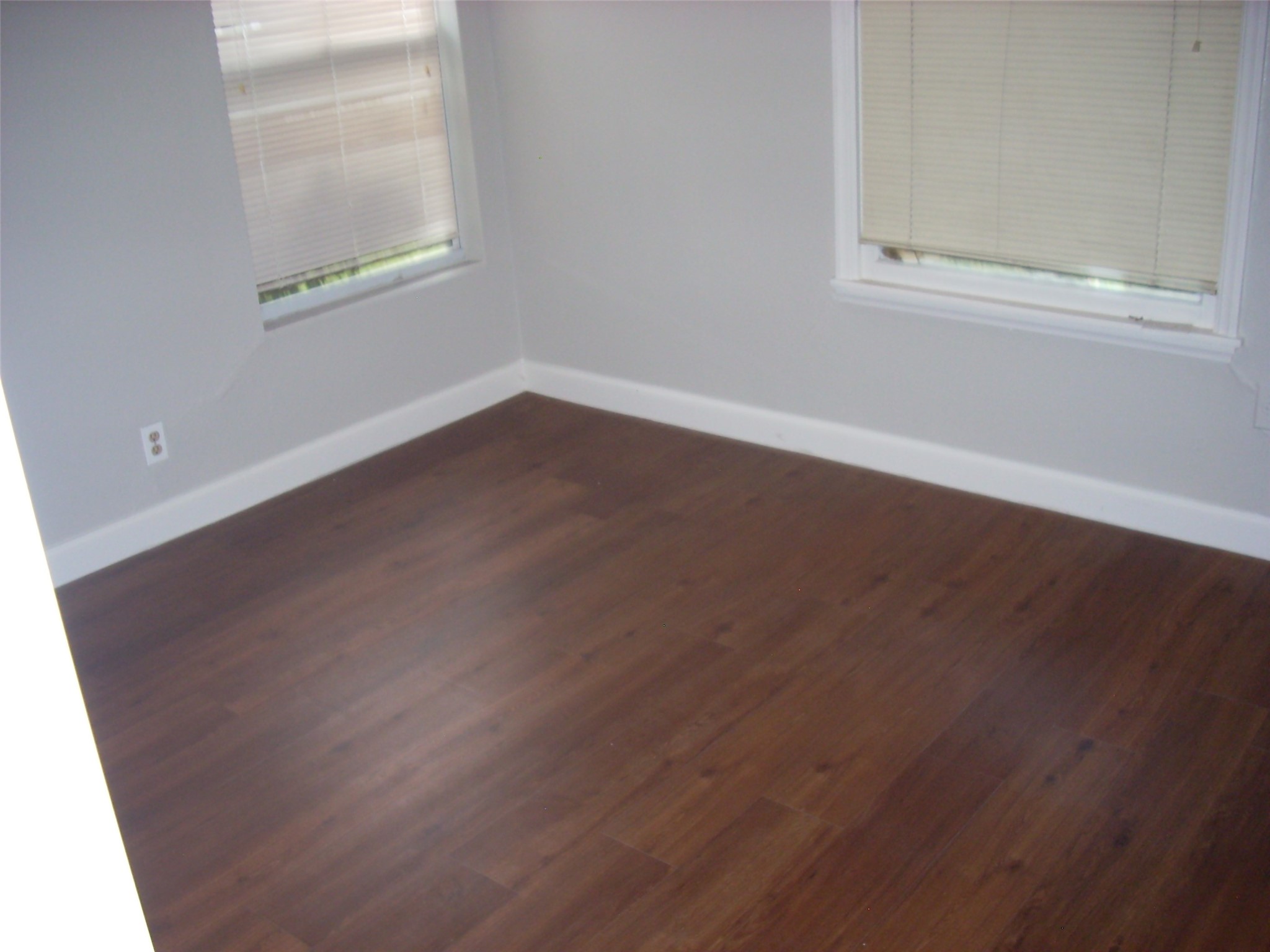 6927 Keller Street Houston, TX 77087 - Photo 6 of 11 an empty room with wooden floor and windows
