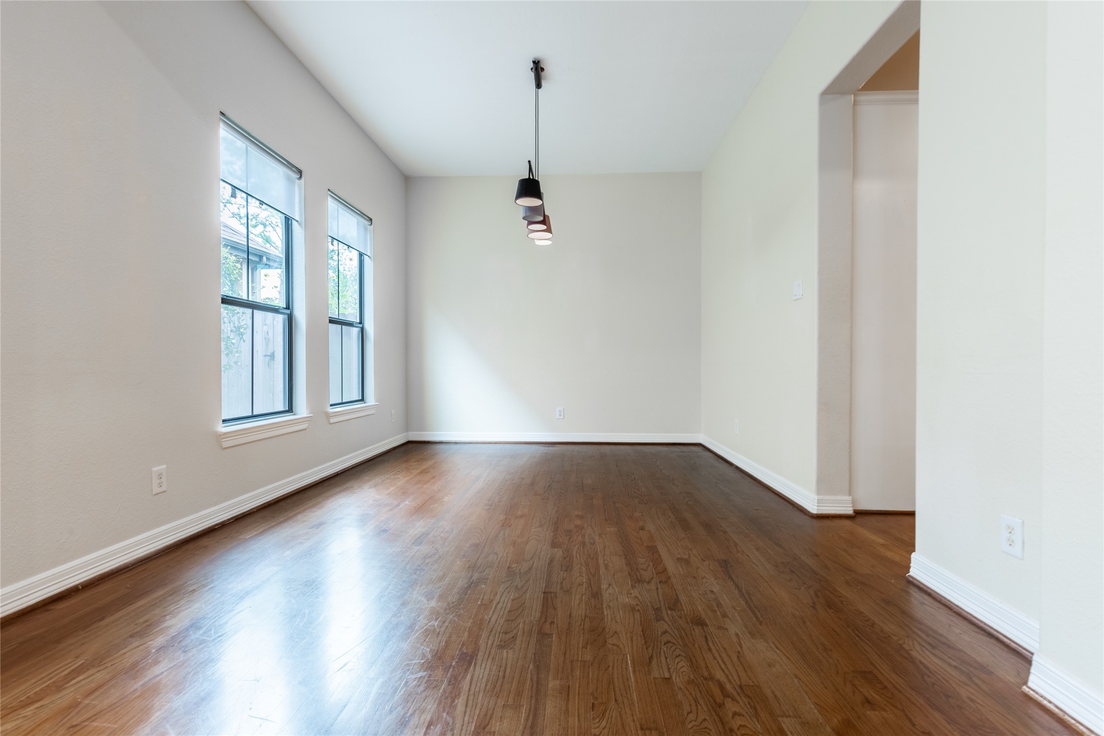 2923 Royal Oaks Crest Houston, TX 77082 - Photo 9 of 31 an empty room with wooden floor and windows