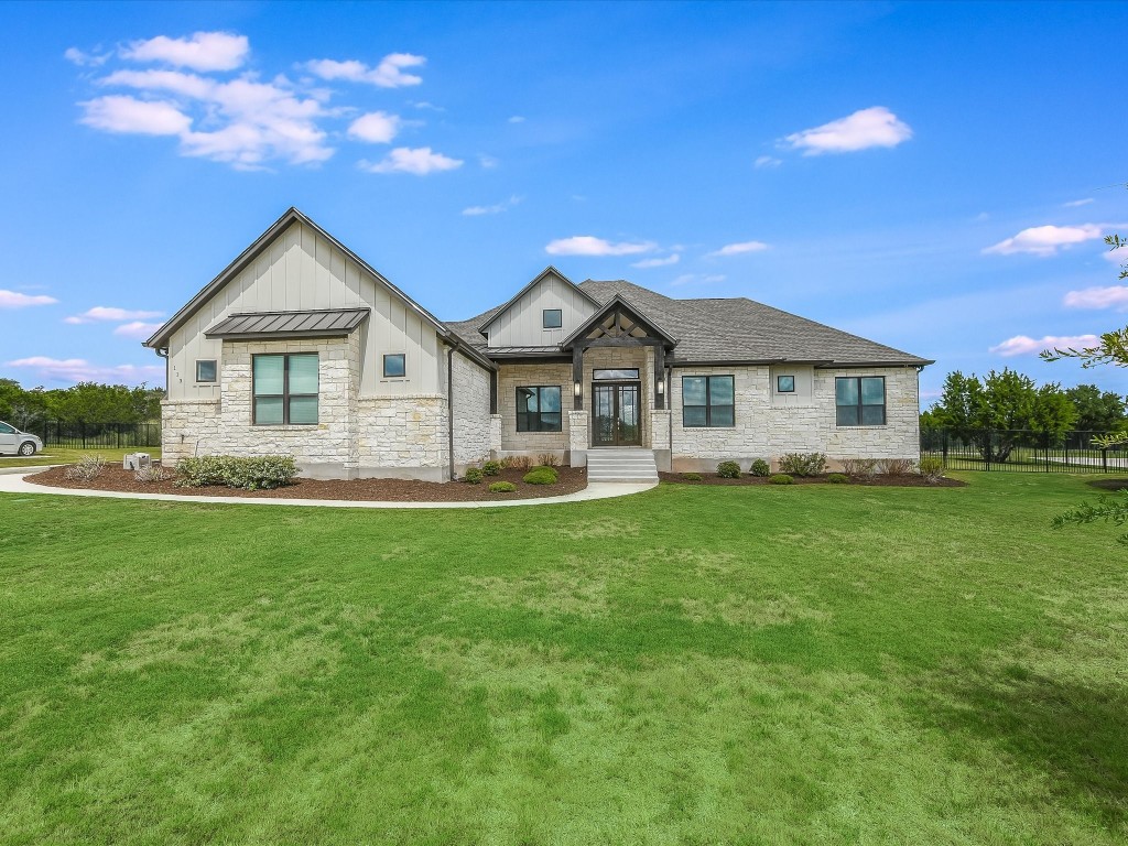 113 Tesoro Perdido Cove Liberty Hill, TX 78642 - Photo 1 of 31 a front view of a house with a garden and yard