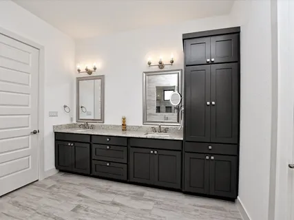 a bathroom with a double vanity sink and mirror