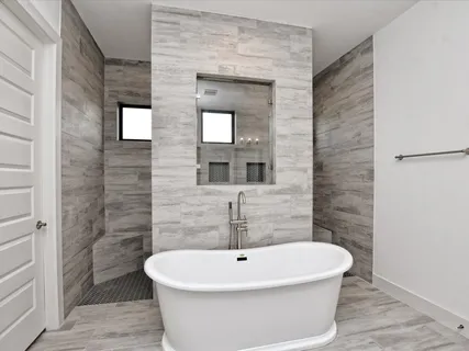 a white bath tub sitting in a bathroom