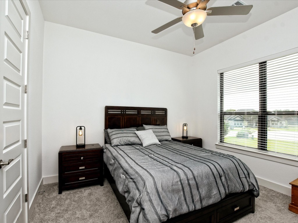 113 Tesoro Perdido Cove Liberty Hill, TX 78642 - Photo 23 of 31 a bedroom with a bed and a window