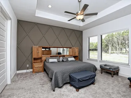 a bedroom with a bed and a ceiling fan