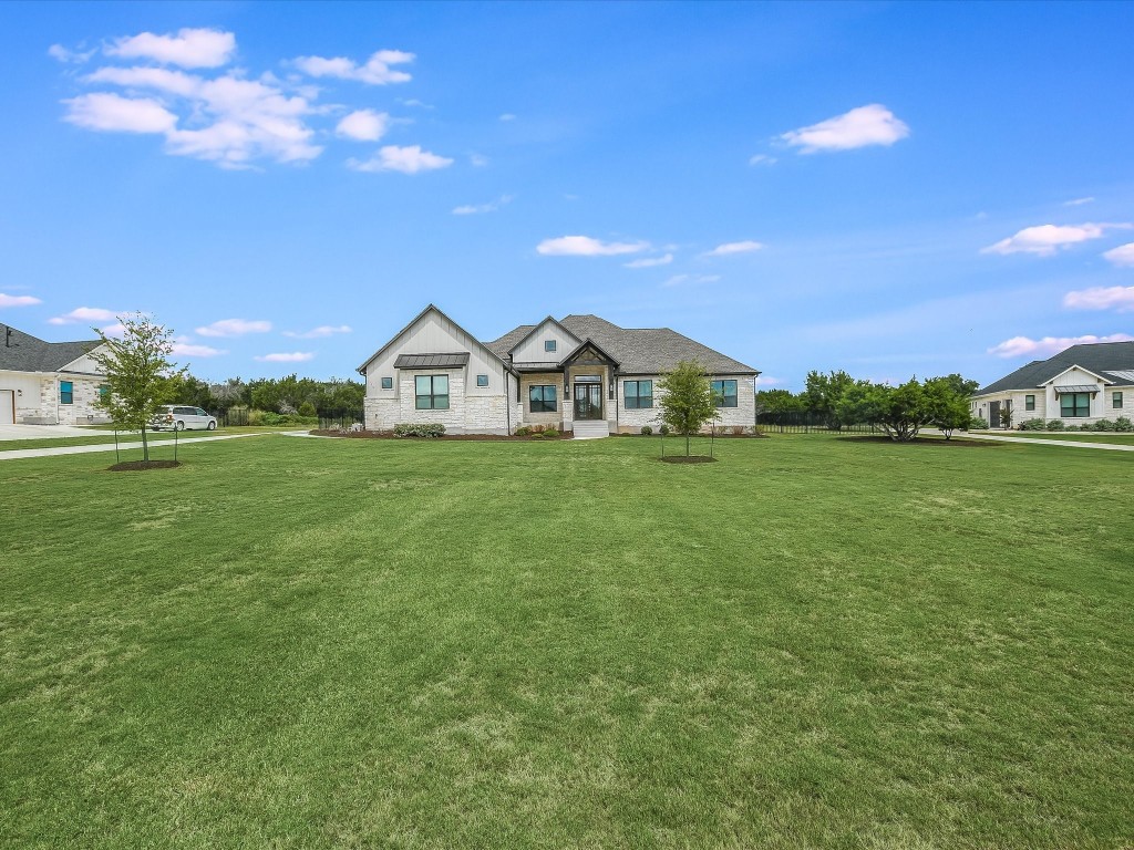 113 Tesoro Perdido Cove Liberty Hill, TX 78642 - Photo 5 of 31 a view of a green field with house in the background