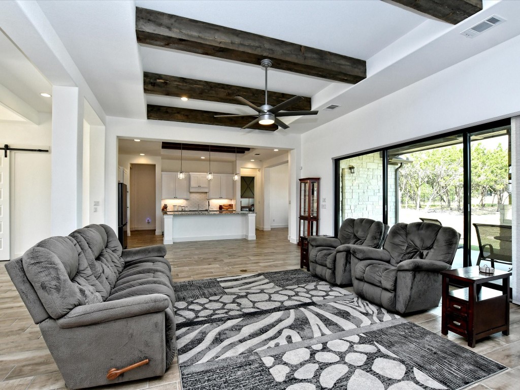 113 Tesoro Perdido Cove Liberty Hill, TX 78642 - Photo 8 of 31 a living room with furniture and a large window