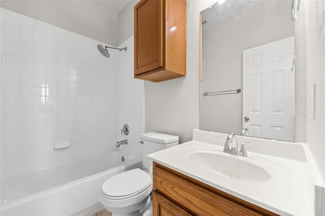 an empty room with a window and a ceiling fan