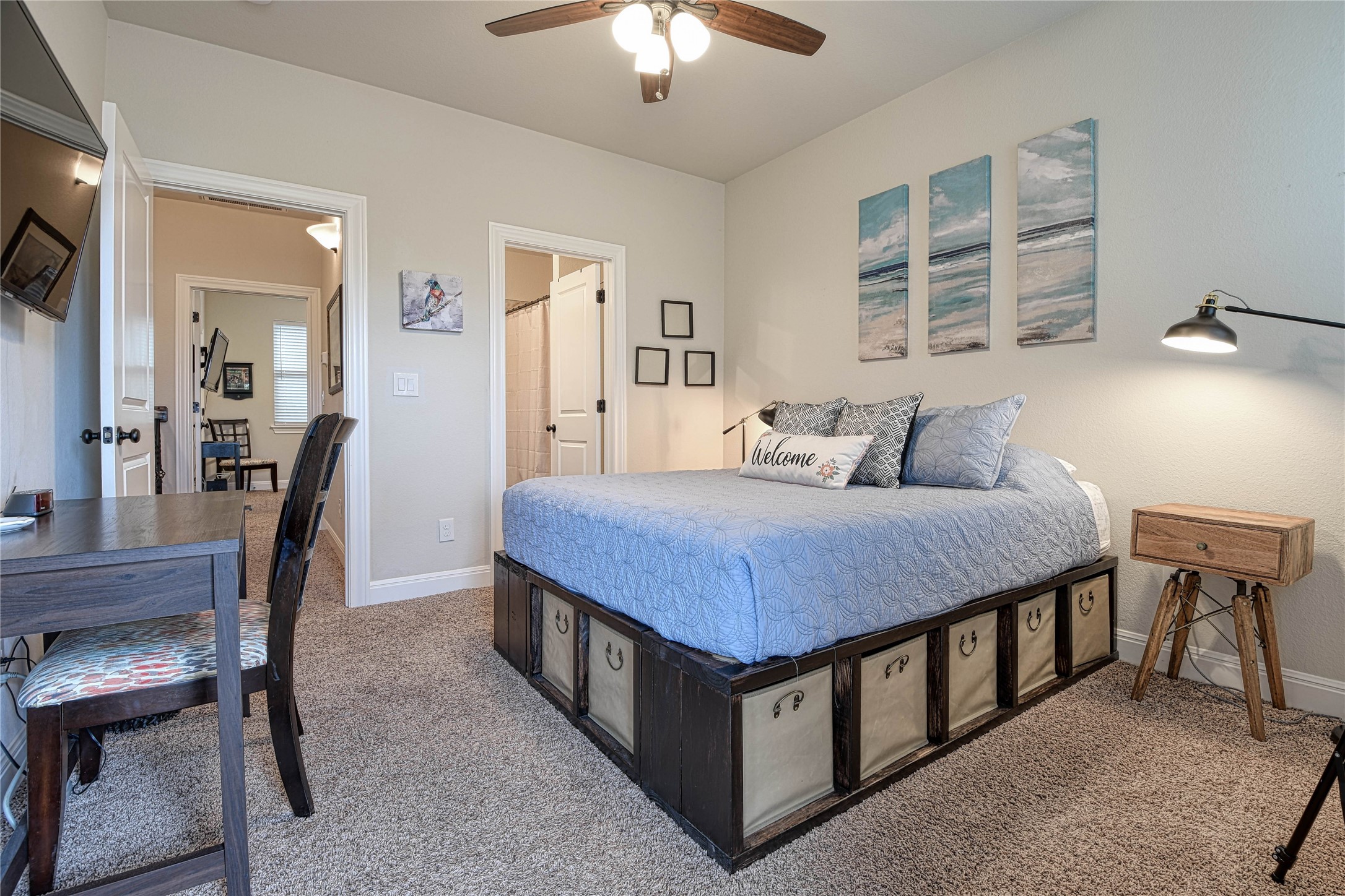 565 Demarett Drive Point Venture, TX 78645 - Photo 12 of 46 a bedroom with a bed a chandelier and a dresser