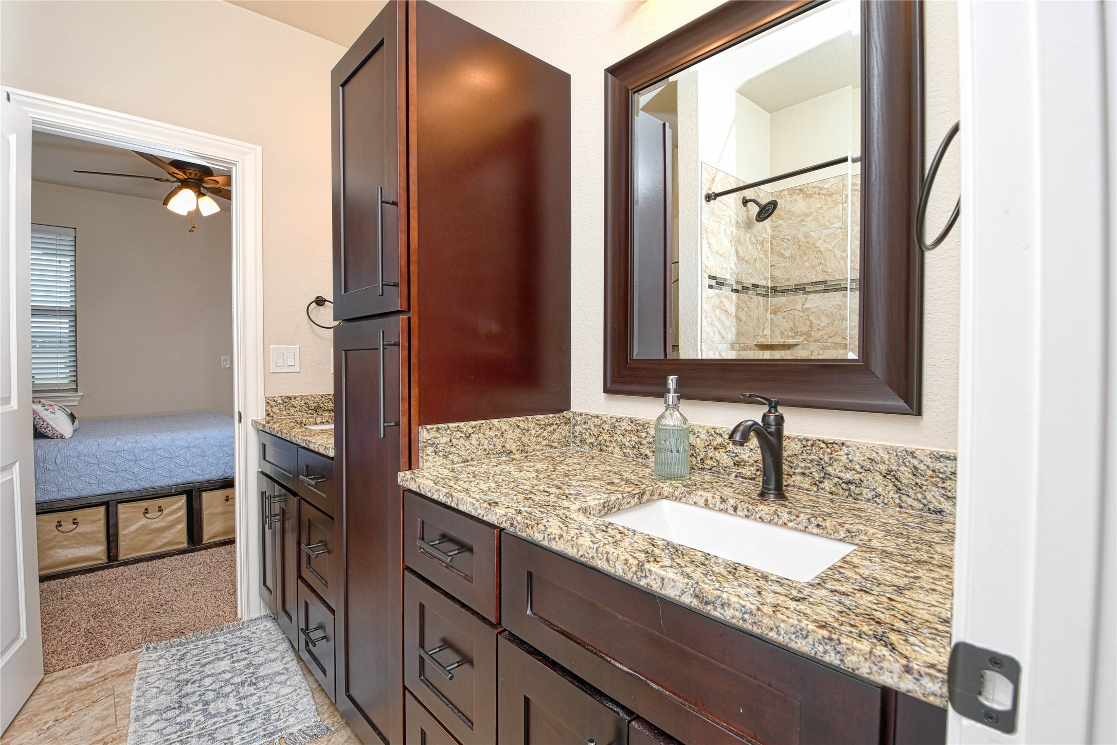 565 Demarett Drive Point Venture, TX 78645 - Photo 13 of 46 a bathroom with a granite countertop sink and a mirror