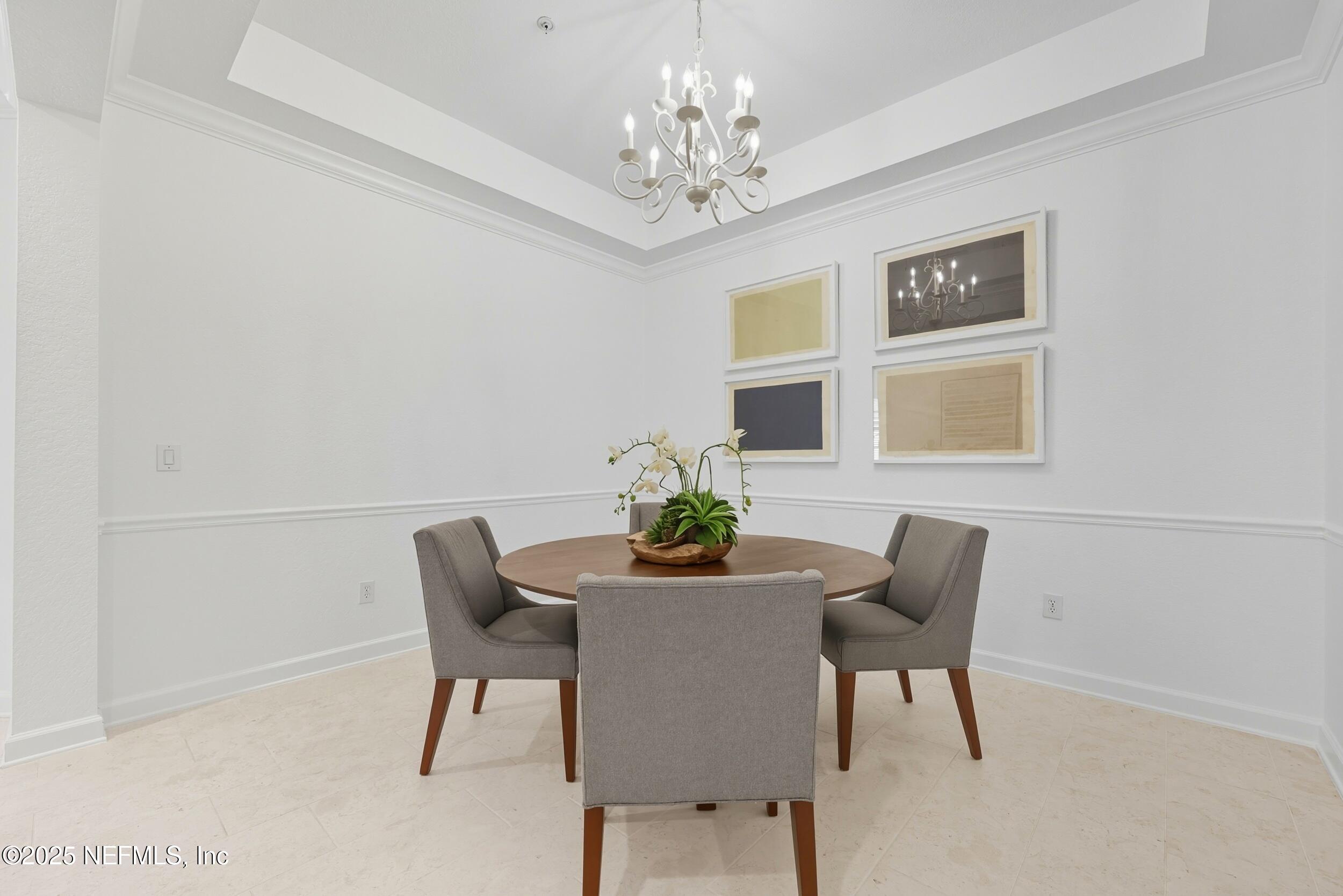 210 Paseo Terraza, Unit 301 St. Augustine, FL 32095 - Photo 11 of 54 a dining room with furniture and chandelier