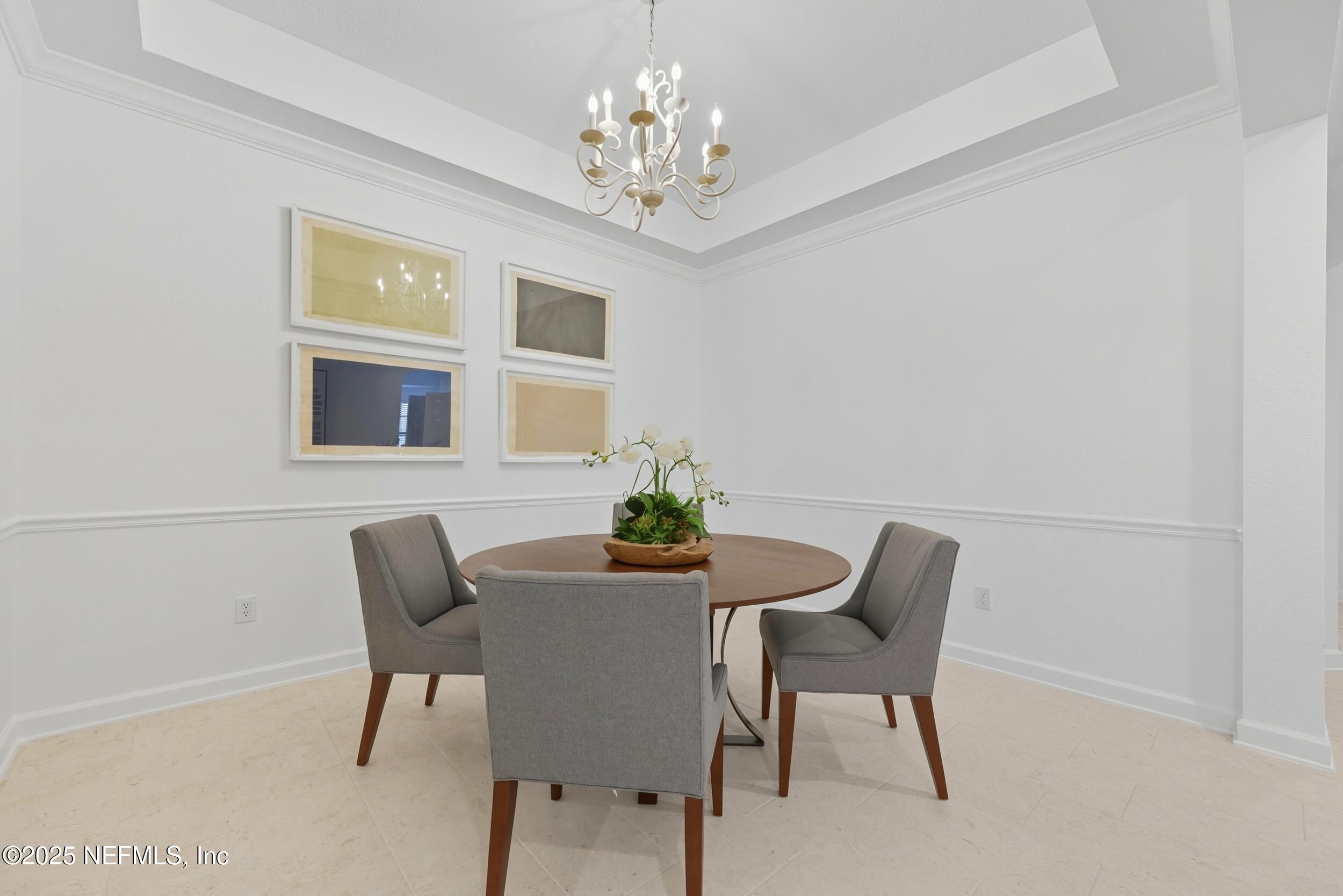 210 Paseo Terraza, Unit 301 St. Augustine, FL 32095 - Photo 12 of 54 a dining room with furniture and chandelier