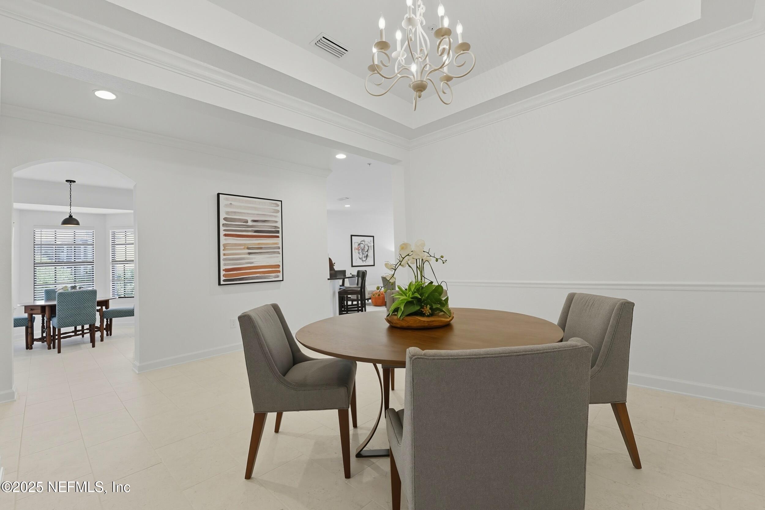 210 Paseo Terraza, Unit 301 St. Augustine, FL 32095 - Photo 13 of 54 a dining room with furniture and chandelier