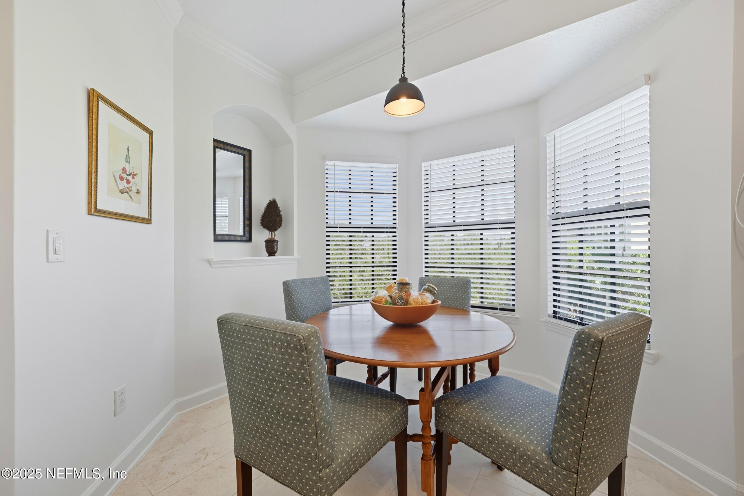 210 Paseo Terraza, Unit 301 St. Augustine, FL 32095 - Photo 14 of 54 a view of a dining room with furniture window and outside view