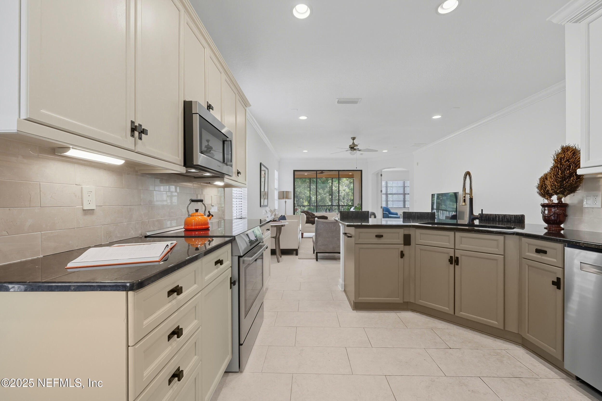 210 Paseo Terraza, Unit 301 St. Augustine, FL 32095 - Photo 16 of 54 a kitchen that has a sink and a stove in it