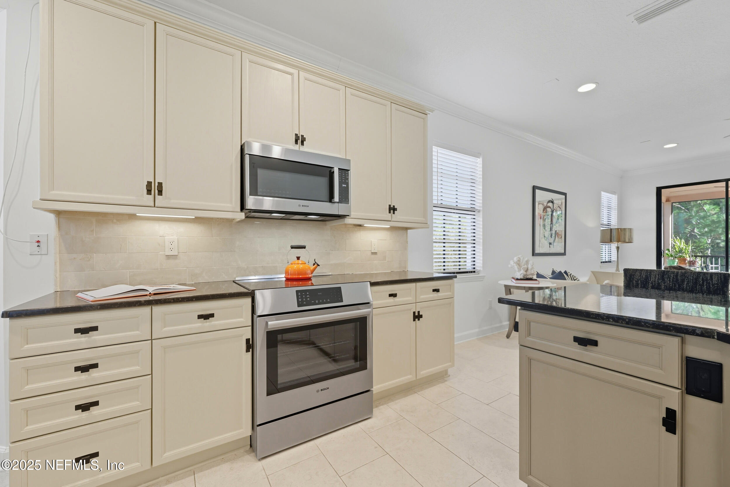 210 Paseo Terraza, Unit 301 St. Augustine, FL 32095 - Photo 17 of 54 a kitchen with granite countertop white cabinets and white appliances