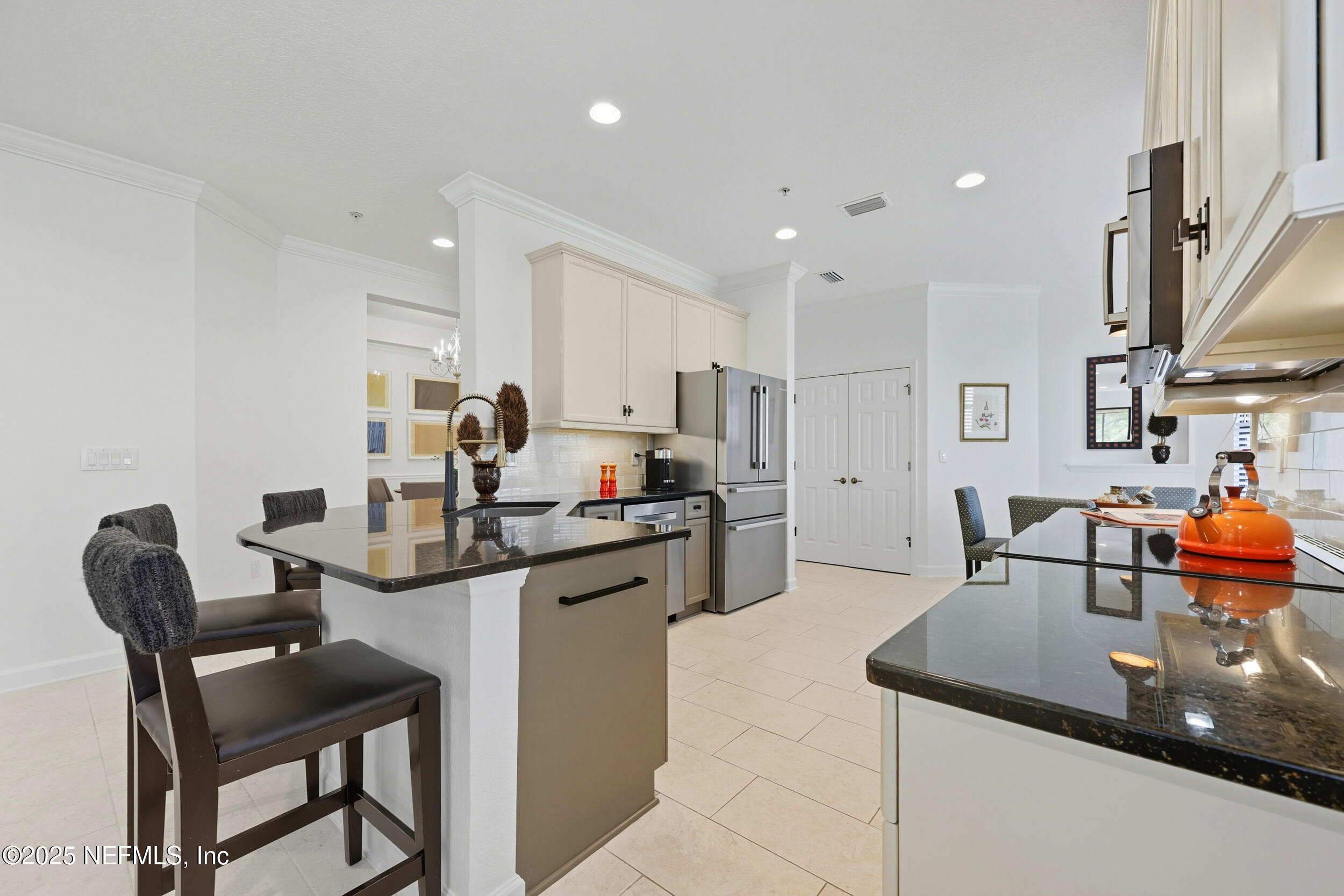 210 Paseo Terraza, Unit 301 St. Augustine, FL 32095 - Photo 18 of 54 a kitchen with stainless steel appliances granite countertop a sink and a refrigerator
